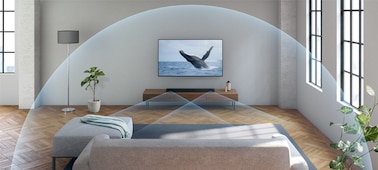 A sofa in front of the TV with sound waves emitting across the room from a sound bar.