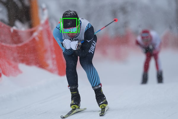 Image of a skier in motion, with a tracking indicator mark superimposed over the skier’s head