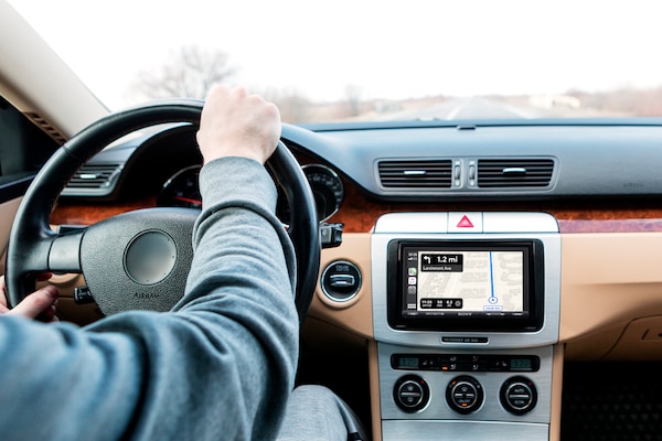 Image of the 6.95 in (17.6 cm) Digital Media Receiver with WebLink Cast in a car with a person driving.